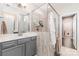 Modern bathroom with glass-enclosed shower, double vanity, and neutral color scheme at 6029 Phyliss Ln, Mint Hill, NC 28227