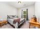 Bedroom with a large window, ceiling fan, two side tables, and a desk at 6029 Phyliss Ln, Mint Hill, NC 28227