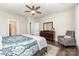 Bedroom with ceiling fan, hardwood floors, accent chair, and en-suite bathroom access at 6029 Phyliss Ln, Mint Hill, NC 28227