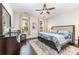 Bright bedroom featuring hardwood floors, ceiling fan, and a large window with natural light at 6029 Phyliss Ln, Mint Hill, NC 28227
