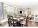 Open dining area featuring a wood table set, chandelier, and view into the adjacent living room at 6029 Phyliss Ln, Mint Hill, NC 28227