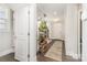 Bright entryway with hardwood floors, staircase, and decorative plants at 6029 Phyliss Ln, Mint Hill, NC 28227