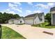 View of multiple garages with driveways, set against a backdrop of lush greenery at 6029 Phyliss Ln, Mint Hill, NC 28227