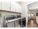 Well-equipped laundry room with modern washer and dryer, white cabinetry, and access to kitchen at 6029 Phyliss Ln, Mint Hill, NC 28227