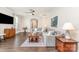 Inviting living room featuring a comfortable gray sectional sofa, ceiling fan, and stylish decor at 6029 Phyliss Ln, Mint Hill, NC 28227