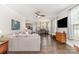 Open-concept living room with hardwood floors, large sofa, and seamless flow to the dining area at 6029 Phyliss Ln, Mint Hill, NC 28227