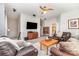 Spacious living room featuring plush leather seating, ceiling fan, and mounted television at 6029 Phyliss Ln, Mint Hill, NC 28227