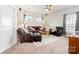 Cozy living room with plush leather seating, accent lamps, and a decorative area rug at 6029 Phyliss Ln, Mint Hill, NC 28227