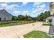 Neighborhood street view featuring landscaped lawns and black fences enhance curb appeal at 6029 Phyliss Ln, Mint Hill, NC 28227