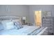 Inviting bedroom featuring comfortable bedding, stylish accents, and a glimpse into the ensuite bathroom at 604 E Ohio Ave, Bessemer City, NC 28016