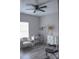 Bedroom featuring a ceiling fan, desk, dresser, chair, and bench against gray walls and wood-look flooring at 604 E Ohio Ave, Bessemer City, NC 28016