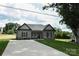 Well-maintained brick home with black accents, landscaped yard, and extended driveway at 604 E Ohio Ave, Bessemer City, NC 28016