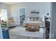 Comfortable living room showcasing stylish decor, natural lighting and glimpses of an adjacent bedroom at 604 E Ohio Ave, Bessemer City, NC 28016