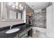 Functional bathroom with a granite vanity, a large mirror, and a shower-tub combination at 6113 Windsor Gate Ln # 6113, Charlotte, NC 28215
