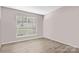 Clean bedroom with wood-look floors, a window, and neutral paint, ready for personalization at 6113 Windsor Gate Ln # 6113, Charlotte, NC 28215