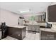 Functional kitchen featuring gray cabinets, stainless steel appliances, and granite countertops at 6113 Windsor Gate Ln # 6113, Charlotte, NC 28215