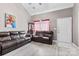 Spacious living room with vaulted ceilings, wood-look floors, and comfortable leather sofas at 6113 Windsor Gate Ln # 6113, Charlotte, NC 28215
