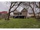 A view of the home's backyard and elevation showing the back porch and access to the crawlspace at 613 E Liberty St, Salisbury, NC 28144