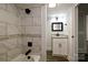 Renovated bathroom featuring updated fixtures, tile shower, and granite counters at 613 E Liberty St, Salisbury, NC 28144