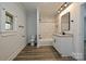 Bathroom with a granite-topped vanity, tiled walls, black hardware, and a shower-tub combination at 613 E Liberty St, Salisbury, NC 28144