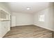 Spacious bedroom with wood-look floors, natural light, and a classic fireplace at 613 E Liberty St, Salisbury, NC 28144