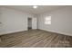 Inviting bedroom with wood-look floors, neutral walls, and a classic fireplace at 613 E Liberty St, Salisbury, NC 28144