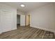 Bedroom featuring wood-look floors, white walls, white doors, and two closets at 613 E Liberty St, Salisbury, NC 28144