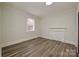 Bedroom with hardwood floors, neutral paint, and a fireplace at 613 E Liberty St, Salisbury, NC 28144