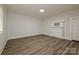 Light-filled bedroom with wood-look floors, neutral walls, and classic fireplace at 613 E Liberty St, Salisbury, NC 28144