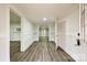 Bright hallway featuring wood-look floors, crisp white trim and neutral walls at 613 E Liberty St, Salisbury, NC 28144
