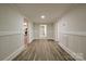 Bright hallway featuring wood-look floors, crisp white trim and neutral walls at 613 E Liberty St, Salisbury, NC 28144