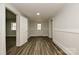 Bright hallway featuring wood-look floors, crisp white trim and neutral walls at 613 E Liberty St, Salisbury, NC 28144