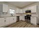 Bright kitchen featuring white cabinets, stainless steel appliances, granite countertops, and modern subway tile backsplash at 613 E Liberty St, Salisbury, NC 28144