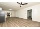 Large living room featuring wood-look flooring, white walls, and a ceiling fan at 613 E Liberty St, Salisbury, NC 28144