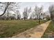 View of a neighborhood green space with mature trees and sidewalk at 613 E Liberty St, Salisbury, NC 28144