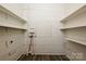 Utility room with wood paneling, storage shelves, and laminate flooring at 613 E Liberty St, Salisbury, NC 28144