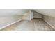Finished attic featuring freshly installed carpet and an energy-efficient mini-split system at 636 Forest Nw St, Concord, NC 28025
