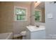 This bathroom features neutral tile and a white vanity sink under a large mirror at 636 Forest Nw St, Concord, NC 28025