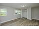 A bright bedroom with wood-look flooring features a closet and large windows at 636 Forest Nw St, Concord, NC 28025