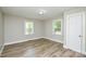 An airy bedroom with natural light features wood-look flooring and fresh paint at 636 Forest Nw St, Concord, NC 28025