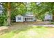 Quaint one-story home with mature trees and a well-maintained lawn at 636 Forest Nw St, Concord, NC 28025