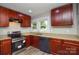 This modern kitchen features stainless appliances, granite countertops, wood cabinetry and a window view at 636 Forest Nw St, Concord, NC 28025