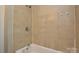 A simple tiled shower stall showcasing the updated fixtures at 636 Forest Nw St, Concord, NC 28025