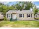 One-story home featuring a white front door and dark shutters, with some damage at 638 E Black St, Rock Hill, SC 29730