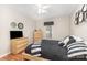 Bedroom featuring hardwood floors, modern decor, natural light, and a mounted television at 713 Hickory Hill Ct, Gastonia, NC 28054