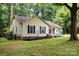 Side view of a cozy home featuring black shutters, landscaping, and a well-maintained lawn and porch at 713 Hickory Hill Ct, Gastonia, NC 28054