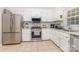 Bright kitchen features stainless steel appliances, granite countertops, and ample cabinet space at 713 Hickory Hill Ct, Gastonia, NC 28054