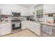 Modern kitchen featuring stainless steel appliances, bright white cabinetry and tile backsplash at 713 Hickory Hill Ct, Gastonia, NC 28054