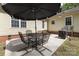 Back patio featuring a patio table with umbrella and grill at 713 Hickory Hill Ct, Gastonia, NC 28054