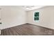Cozy bedroom with wood-look floors and a window overlooking the landscaped yard at 812 Generation Ln, Clover, SC 29710